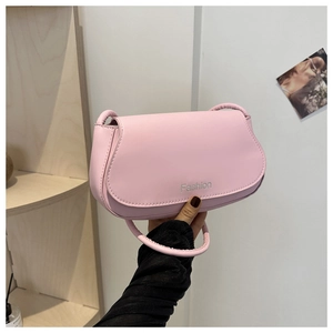 Close-up of light pink saddle bag showing smooth leather texture and Fashion logo