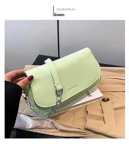 Detail of light green chain shoulder bag with metallic strap and fashion embossing