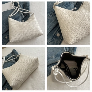 Macro view of woven leather hobo bag showing large capacity for phone and wallet