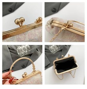 Macro detail of golden vintage clasp and floral embroidery on shell chain bag