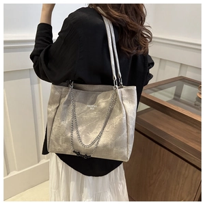 Detail of silver tote bag with dual chains and elegant marble texture finish