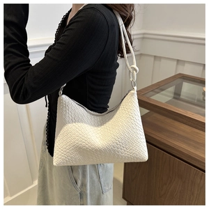 Detail of white woven hobo bag showing high-quality PU leather texture and shoulder strap
