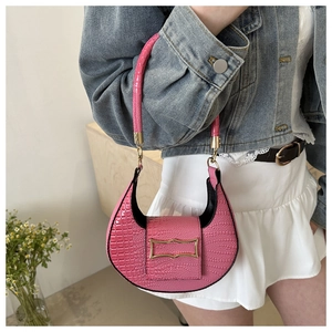 Close-up of pink crescent underarm bag featuring premium crocodile pattern and gold buckle