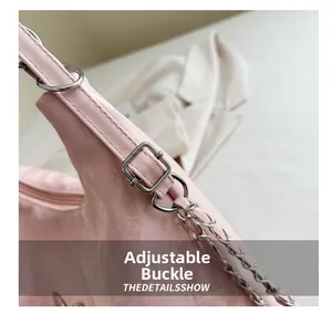 Vue détaillée de la boucle argentée réglable et de la chaîne en métal sur le sac rose
