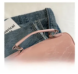 Close-up of pink marble texture handbag featuring an elegant silver butterfly buckle