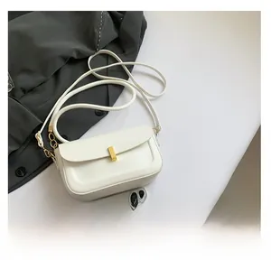 Detailed view of white PU leather crossbody bag with a sleek gold rectangular clasp buckle