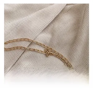Detail of high-quality gold metal chain strap on textured silk embroidery evening bag