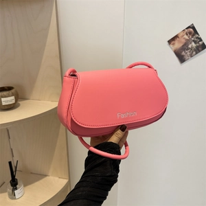 Minimalist pink leather underarm bag with Fashion logo shown in a lifestyle setting