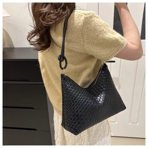 Close-up of a black woven hobo bag featuring Intrecciato texture and leather knot detail