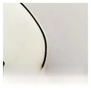 Close-up of white leather texture with black contrast piping on a crescent shoulder bag