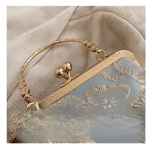 Detail of golden metal lock with cloud pattern and floral embroidery on blue silk bag