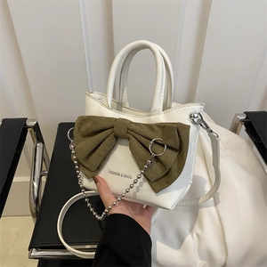 White leather bucket bag with olive green bow and silver bead chain strap details
