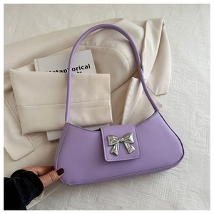 Detailed view of lavender baguette bag with a silver metallic bow buckle and PU leather