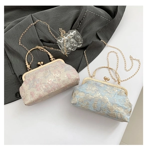 Detail view of vintage shell bags with floral jacquard fabric and gold chain straps