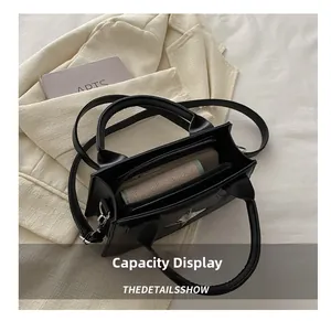 Vista interna della borsa in pelle PU nera con scomparto principale e tasca a zip