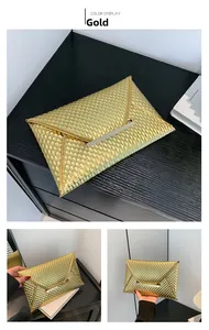 Detail of gold envelope evening bag showing fish scale texture and metal trim