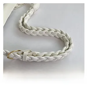 Detail view of white lychee grain leather braided strap with premium gold metal buckle