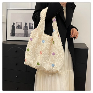 Detail of floral tote bag with plush texture and colorful flower patterns on a shoulder strap