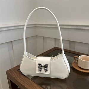 Elegant white leather shoulder bag with a silver metal bow buckle for a minimalist look