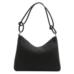 Modern black woven leather tote bag with a minimalist crescent shape and silver metal hardware