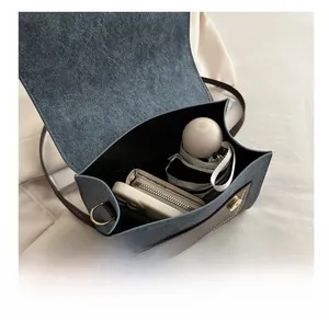 Internal view of blue denim crossbody bag showing space for umbrella and wallet