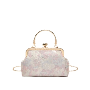 Vintage floral jacquard handbag with gold metal top handle and crossbody chain strap