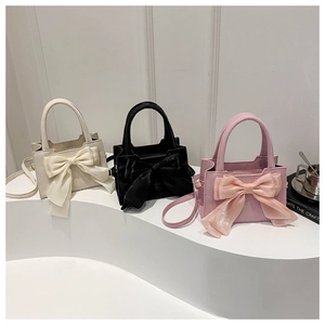 Elegant bow-knot crossbody bag set in white, black, and pink with a matte leather texture