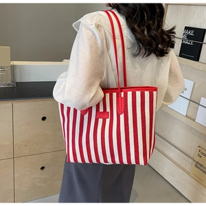 Detailed shot of red and white striped canvas tote bag with slim shoulder straps
