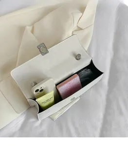 Vue détaillée de l'intérieur d'un sac blanc montrant la capacité et les cosmétiques