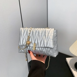 Silver quilted leather crossbody bag with gold chain strap and metallic finish