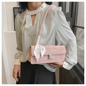 Détail du sac sous le bras rose mat avec boucle en strass et foulard en soie décoratif