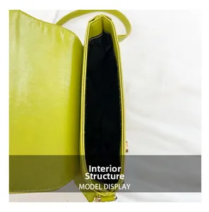 Internal view of the lime green straw crossbody bag showing the black lining and compartment