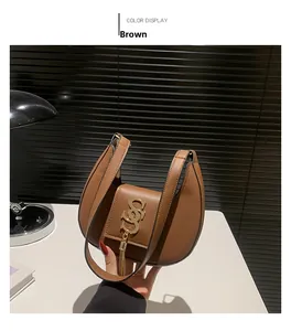 Brown leather saddle bag featuring a gold metal logo and fringe tassel accessory