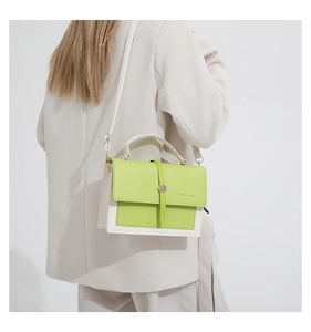 Detail of green and white color-block crossbody bag with metal buckle and fashion logo