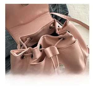 Close-up of pink bucket bag with drawstring closure, metal eyelets and magnetic snap button