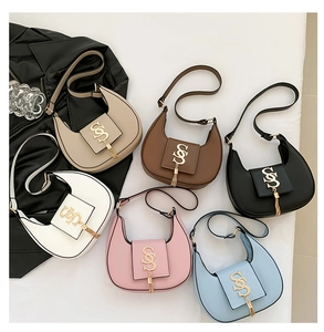 Detail of multi-color half-moon underarm bags with gold S-buckle and chain tassels
