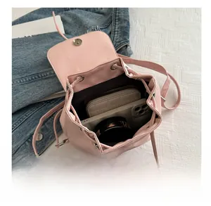 Interior view of pink mini backpack showing phone, wallet and compact in the storage