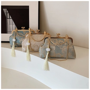 Detailed embroidery on vintage silk handbags with gold frames and long tassels