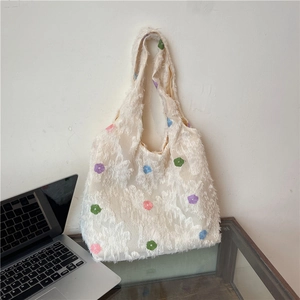 White floral tote bag with fringe texture and colorful embroidered flower patterns