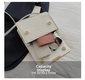 Detail showing white crocodile pattern handbag capacity with wallet and power bank