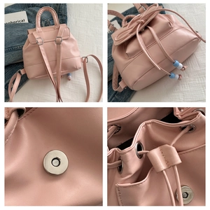 Detailed macro view of pink PU leather backpack showing drawstring and magnetic closure