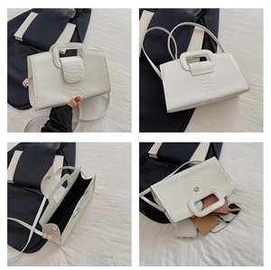 Detail view of white crocodile pattern tote showing interior capacity and handle design