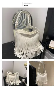Detail of white fringe shoulder bag with braided strap and gold hardware