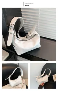 Close-up of white leather shoulder bag with metallic buckle and glossy finish detail