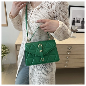 Green triangle quilted bag with gold hardware shown in a stylish lifestyle setting