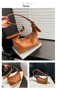 Detail of brown PU leather shoulder bag featuring silver metal buckle and dual zipper closure