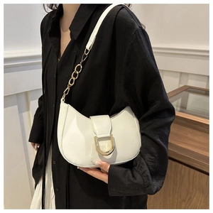 Detail of white glossy leather underarm bag with gold chain and metal buckle
