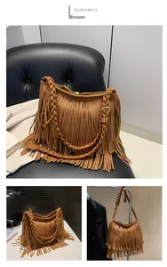 Detail showing brown leather fringe bag with woven shoulder strap in bohemian style
