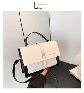 Detail of the high-quality white and black panelled handbag with gold fashion logo print