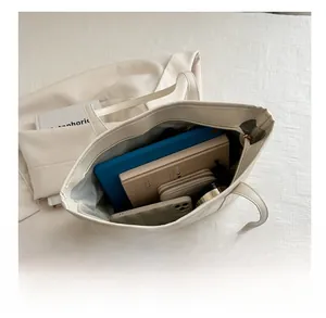 Interior view showing large capacity of the beige tote bag with daily essentials
